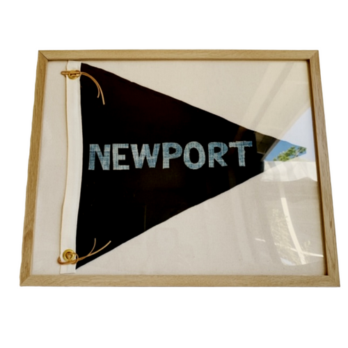 Black linen pennant flag in a salt oak frame featuring hand cut denim lettering that spells NEWPORT in a horizontal orientation