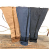 side view of camel, navy, and black pant with silky ribbon visible all with bottom rolled hung over a railing