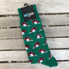 Forest green men's socks with dogs wearing red christmas scarves.