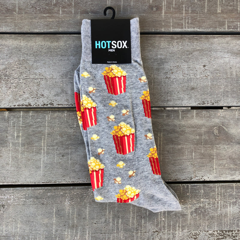Grey men's socks with red and white tubs of yellow popcorn.