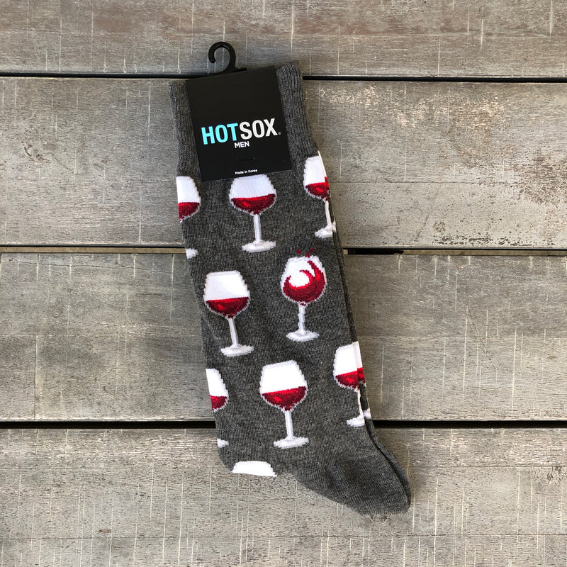 Dark grey men's socks with glasses of red wine.