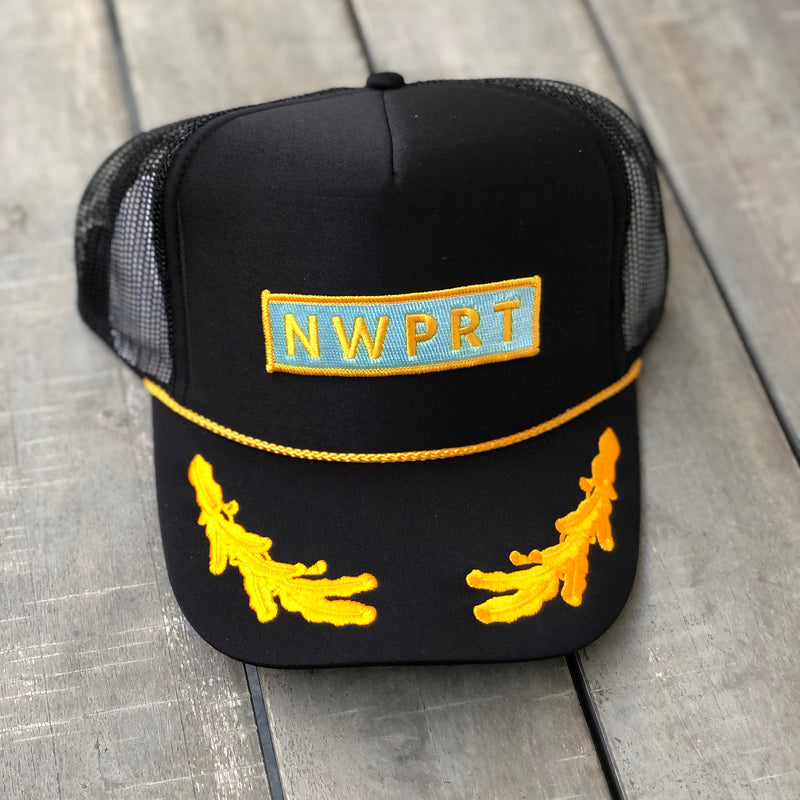 Black foam trucker hat with mesh back with a NWPRT patch, yellow cord around crown and yellow patches on brim.