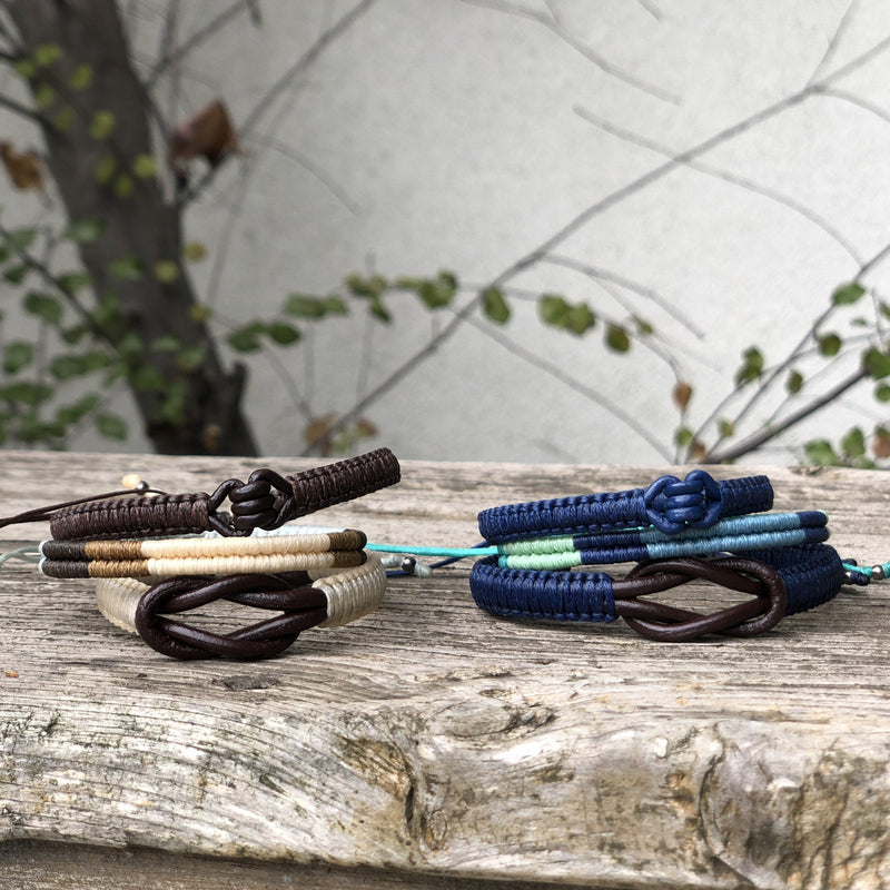 This is a collection of various macrame bracelets in shades of blue and natural.