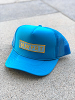 Turquoise foam trucker hat with mesh back by NWPRT with a NWPRT patch.