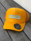 Golden yellow foam trucker hat with snapback/mesh back by NWPRT Supply Co. with NWPRT patch.