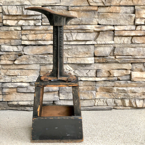 Vintage Cast Iron Shoe Cobbler Stand on a black weathered wooden base.