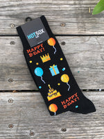 Black men's socks with balloons, cake, gifts and the phrase 'Happy B-day'.