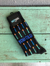 Black men's socks with multi colored birthday candles and the phrase 'you old'.