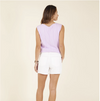 Back view of female model wearing the Carve Helena Top in lilac, and white Oahu shorts.