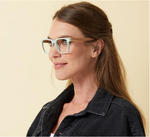 The side view of a woman modeling the Peepers Homespun reading glasses in mint/wood. These frames have a speckled, matte appearance with zebrawood temples.