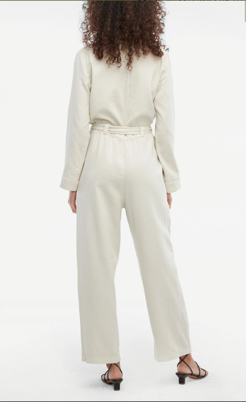This is a back view of the Ludlow Jumpsuit, in a light tan/oatmeal color. It showcases the fabric belt.