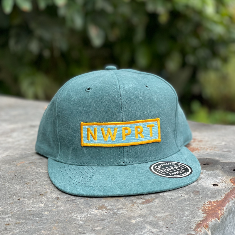 Jade green 6-panel hat with snapback canvas back by NWPRT with a NWPRT patch.