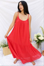 red supremely comfortable spaghetti strap dress with rounded neck that reaches ankles on model.