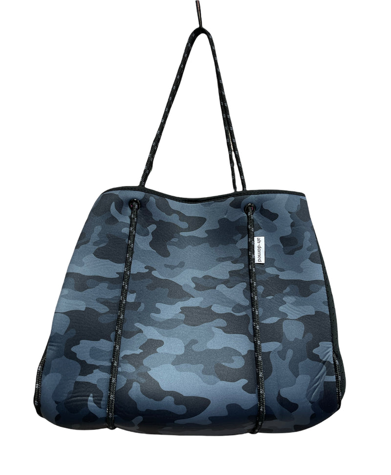 large blue camo bag with narrow black and gray rope strap. The straps also decorate the pouch as they loop around