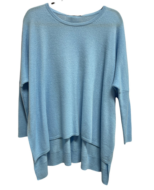 sky blue top with a round neck. the front is shorter than the back and the sleeves are ribbed at the elbow