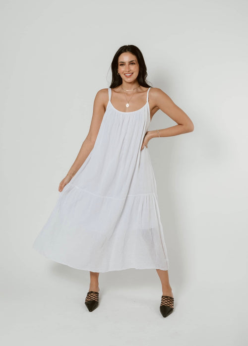white supremely comfortable spaghetti strap dress with rounded neck that reaches mid calf on model
