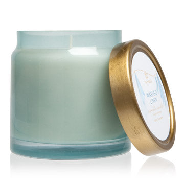 This candle has a delicate and wooded scent. It smells like freshly laundered sheets, dried with an outdoor breeze. Refreshing notes of fresh cedarwood, calming lavender and white pepper are rounded out with an intriguing touch of grapefruit, orange flower and amber. It comes in a beautiful blue glass with a gold lid and top label. It has a non-metal wick that provides a clean, pure burn time of approximately 64 hours.
