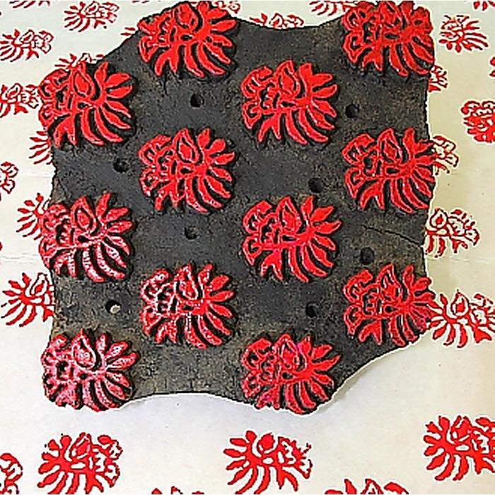 Woodblock with red ink on the hand carved floral motifs. 